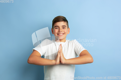 Image of Caucasian teen\'s portrait isolated on blue studio background