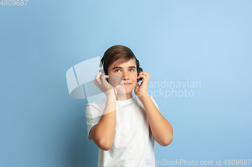 Image of Caucasian teen\'s portrait isolated on blue studio background
