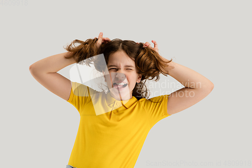 Image of Caucasian girl isolated on white studio background. Copyspace. Childhood, education, emotions concept
