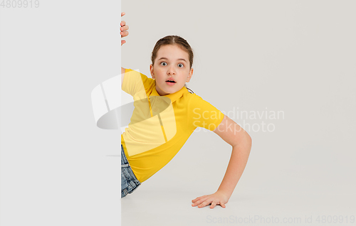 Image of Caucasian girl isolated on white studio background. Copyspace. Childhood, education, emotions concept