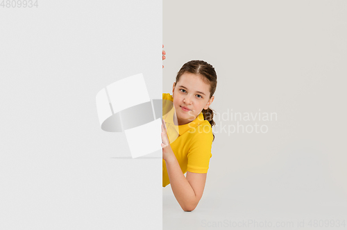 Image of Caucasian girl isolated on white studio background. Copyspace. Childhood, education, emotions concept