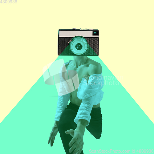 Image of Contemporary art collage, modern design. Retro style. Beautiful male dancer headed by retro camera running on yellow background