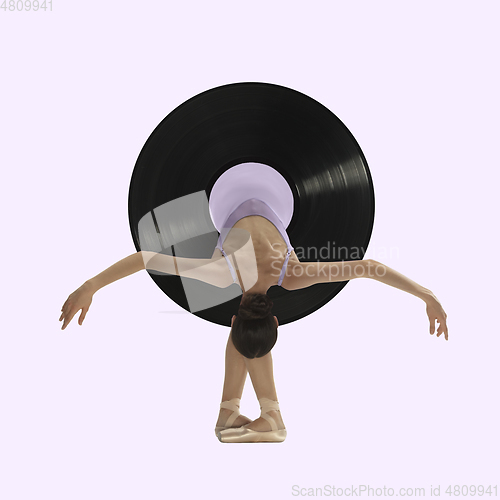 Image of Contemporary art collage, modern design. Retro style. Beautiful ballerina in vinyl plate dancing on purple background