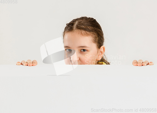 Image of Caucasian girl isolated on white studio background. Copyspace. Childhood, education, emotions concept