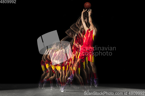 Image of Young caucasian basketball player in motion and action in mixed light on dark background. Concept of healthy lifestyle, professional sport, hobby.