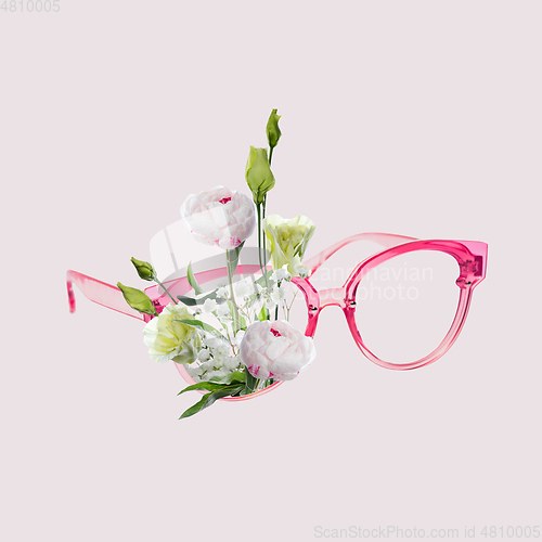 Image of Contemporary art collage, modern design. Retro style. Eyeglasses with bouquet with blooming spring flowers on pastel background