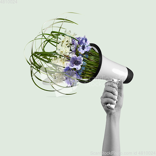 Image of Contemporary art collage, modern design. Retro style. Megaphone with bouquet with blooming spring flowers on pastel background.