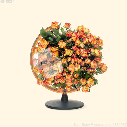 Image of Contemporary art collage, modern design. Retro style. Globe with bouquet with blooming spring flowers on pastel background