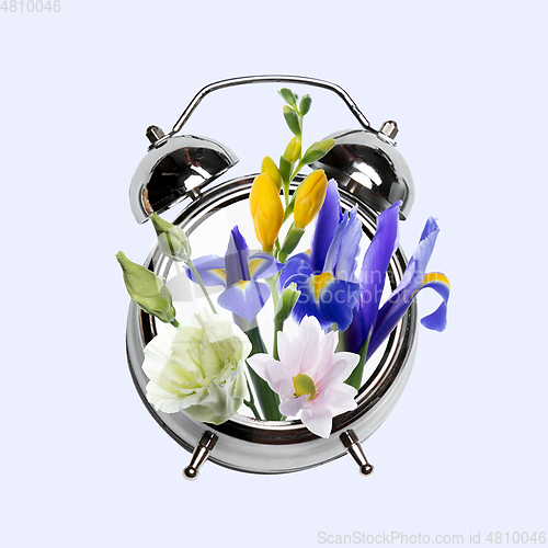 Image of Contemporary art collage, modern design. Retro style. Clock with bouquet with blooming spring flowers on pastel background