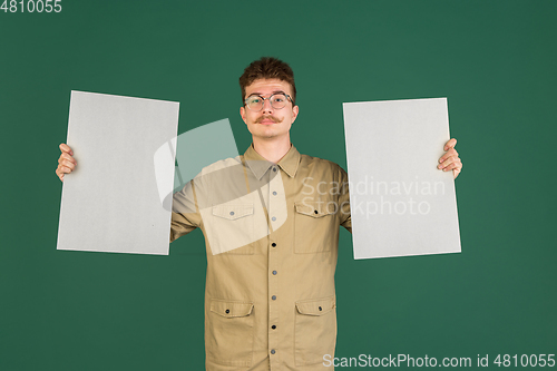 Image of Caucasian man\'s portrait isolated over green studio background with copyspace