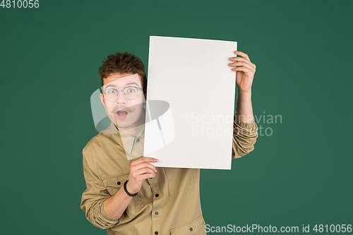 Image of Caucasian man\'s portrait isolated over green studio background with copyspace