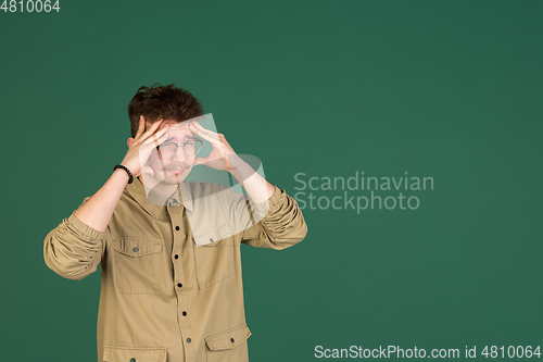 Image of Caucasian man\'s portrait isolated over green studio background with copyspace