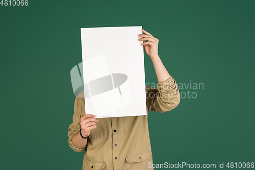 Image of Caucasian man\'s portrait isolated over green studio background with copyspace