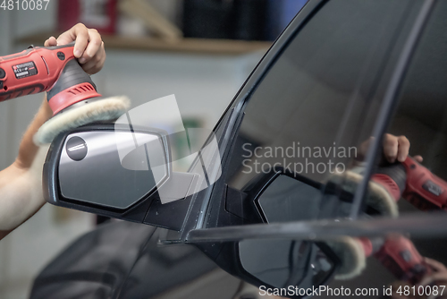 Image of professional polishing and buffing detailing service on an autom
