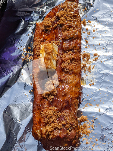 Image of Close-up view of delicious juicy meat with ribs on grill