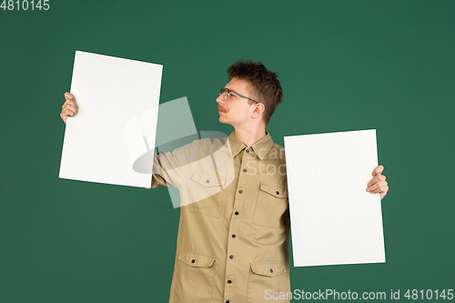 Image of Caucasian man\'s portrait isolated over green studio background with copyspace