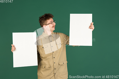 Image of Caucasian man\'s portrait isolated over green studio background with copyspace