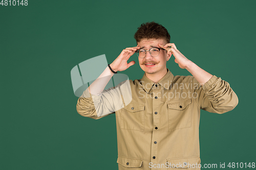 Image of Caucasian man\'s portrait isolated over green studio background with copyspace