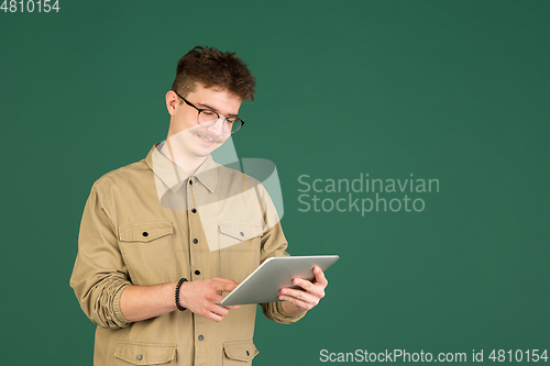 Image of Caucasian man\'s portrait isolated over green studio background with copyspace