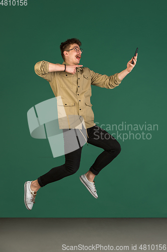 Image of Caucasian man\'s portrait isolated over green studio background with copyspace