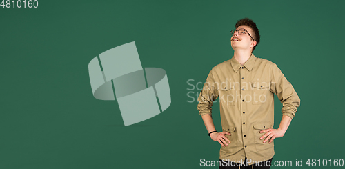 Image of Caucasian man\'s portrait isolated over green studio background with copyspace
