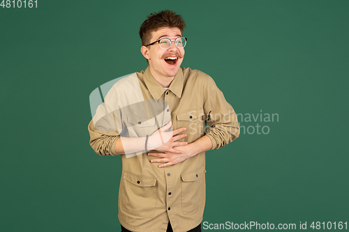 Image of Caucasian man\'s portrait isolated over green studio background with copyspace