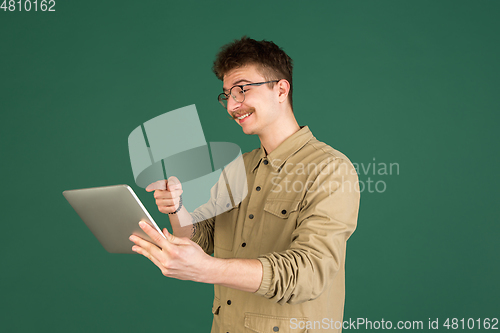 Image of Caucasian man\'s portrait isolated over green studio background with copyspace