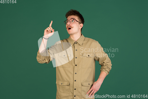 Image of Caucasian man\'s portrait isolated over green studio background with copyspace