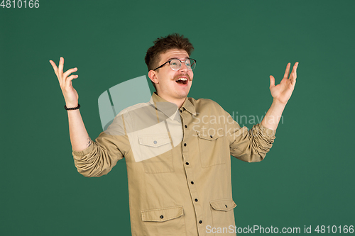 Image of Caucasian man\'s portrait isolated over green studio background with copyspace