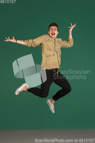 Image of Caucasian man\'s portrait isolated over green studio background with copyspace