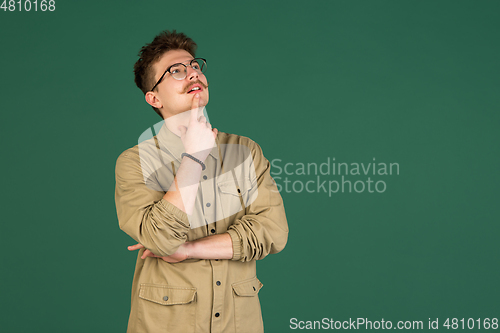 Image of Caucasian man\'s portrait isolated over green studio background with copyspace