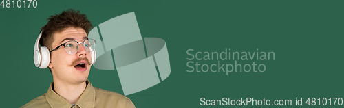 Image of Caucasian man\'s portrait isolated over green studio background with copyspace