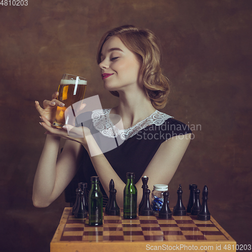 Image of Young woman in art action isolated on brown background. Retro style, comparison of eras concept.