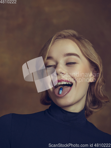 Image of Young woman in art action isolated on brown background. Retro style, comparison of eras concept.