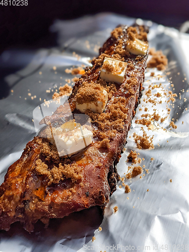 Image of Close-up view of delicious juicy meat with ribs on grill