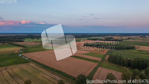 Image of Sunset aerial landscape of filds and meadows