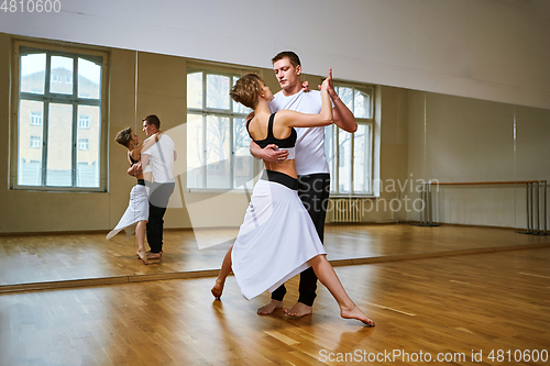 Image of beautiful couple dancing tango