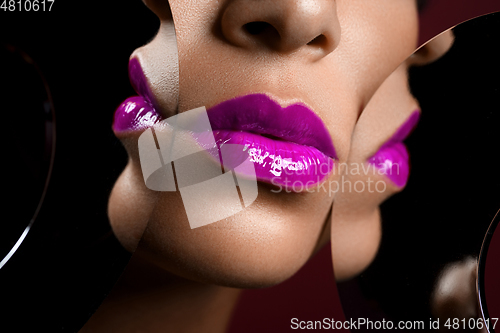 Image of beautiful woman lips closeup with mirror reflections