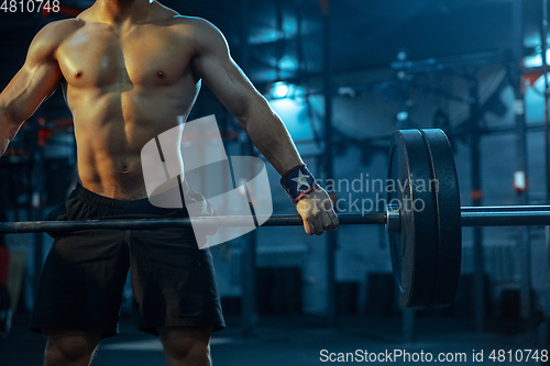 Image of Caucasian man practicing in weightlifting in gym