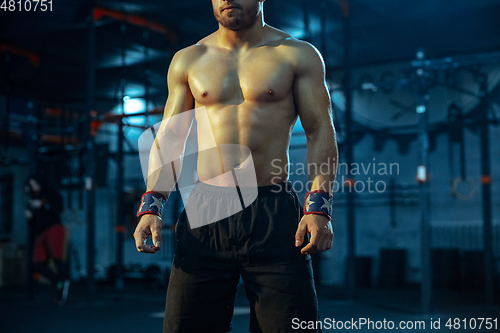 Image of Caucasian man practicing in weightlifting in gym