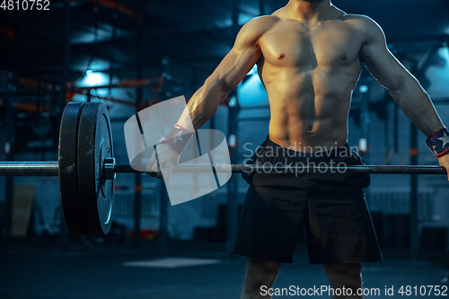 Image of Caucasian man practicing in weightlifting in gym