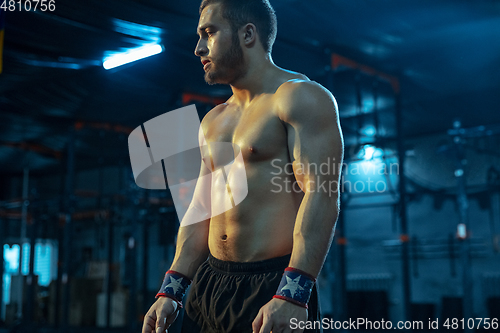 Image of Caucasian man practicing in weightlifting in gym