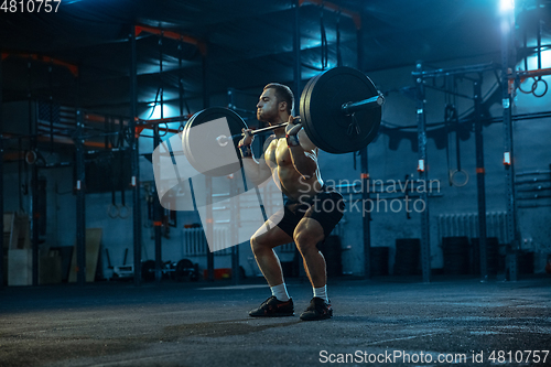 Image of Caucasian man practicing in weightlifting in gym