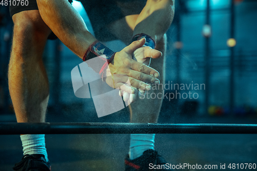 Image of Caucasian man practicing in weightlifting in gym