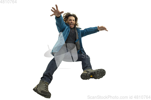 Image of A second before falling - young man falling down with bright emotions and expression