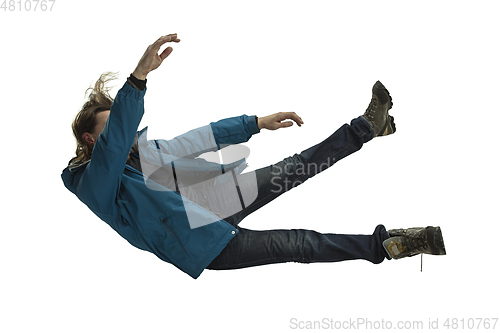 Image of A second before falling - young man falling down with bright emotions and expression