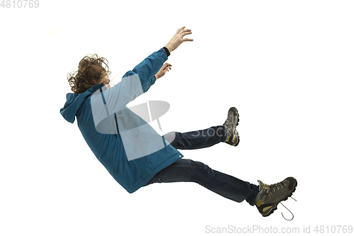 Image of A second before falling - young man falling down with bright emotions and expression