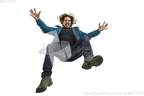 Image of A second before falling - young man falling down with bright emotions and expression