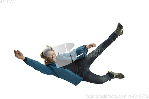 Image of A second before falling - young man falling down with bright emotions and expression