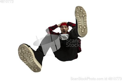 Image of A second before falling - young man falling down with bright emotions and expression